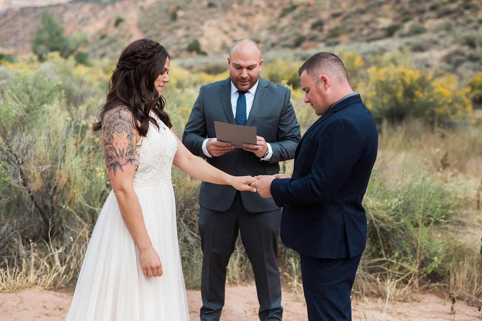 groom puts ring on bride