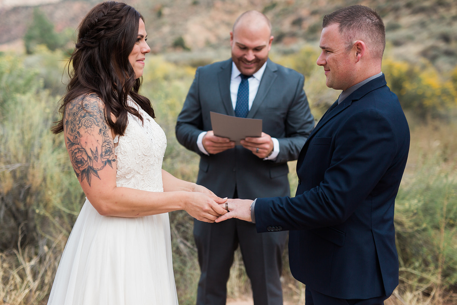 bride puts ring on groom at elopement ceremony