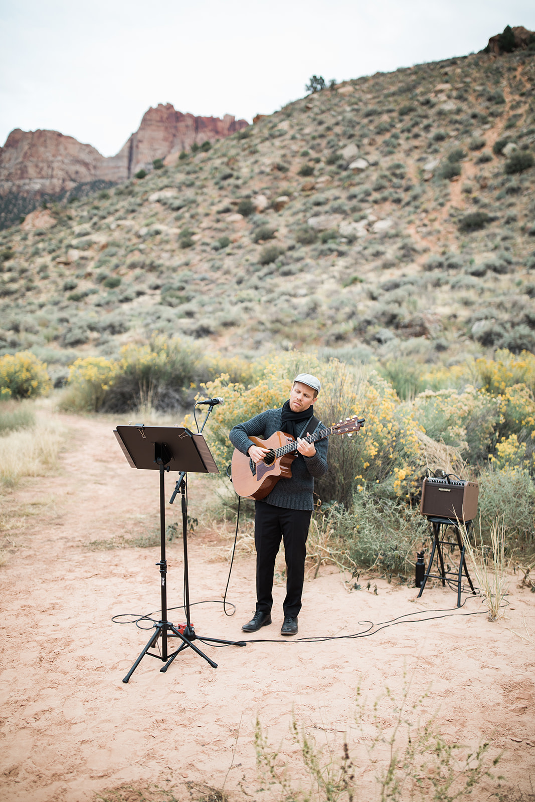 guitarist against Zion mountains for outdoor elopement