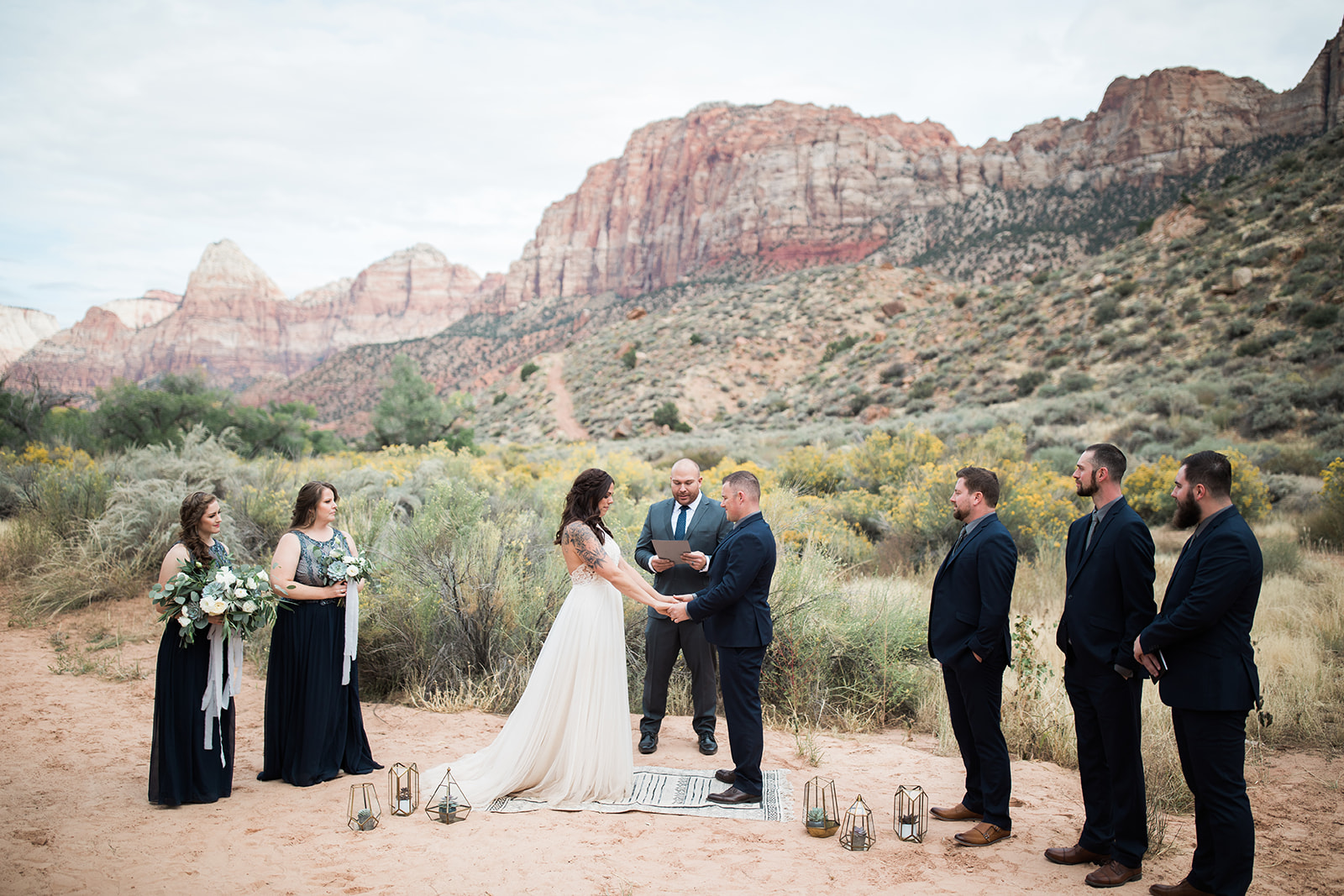 bride and groom join hands for elopement ceremony in Zion