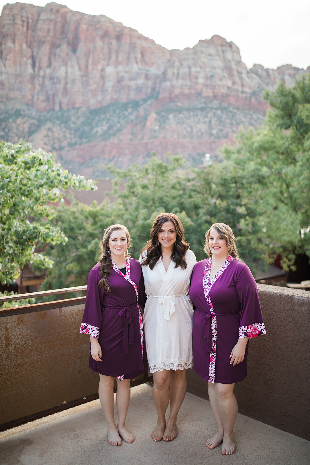 bride and bridesmaids in front of Zion backdrop