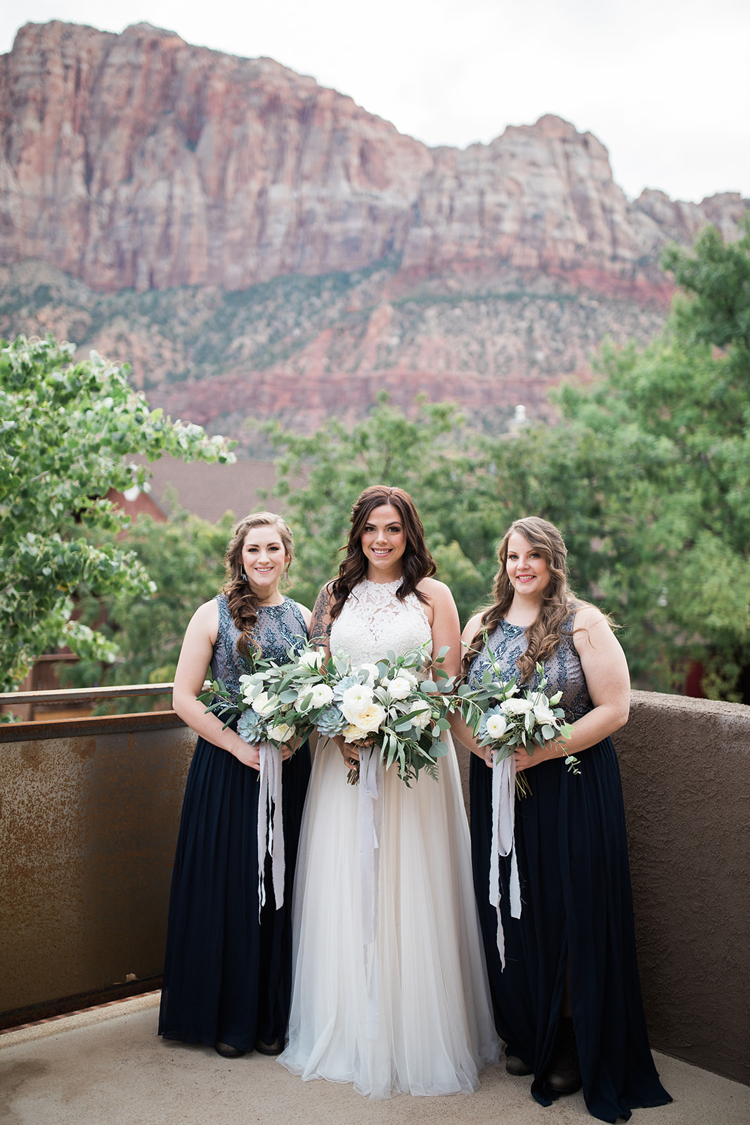 bride and bridesmaids in front of Zion mountain backdrop