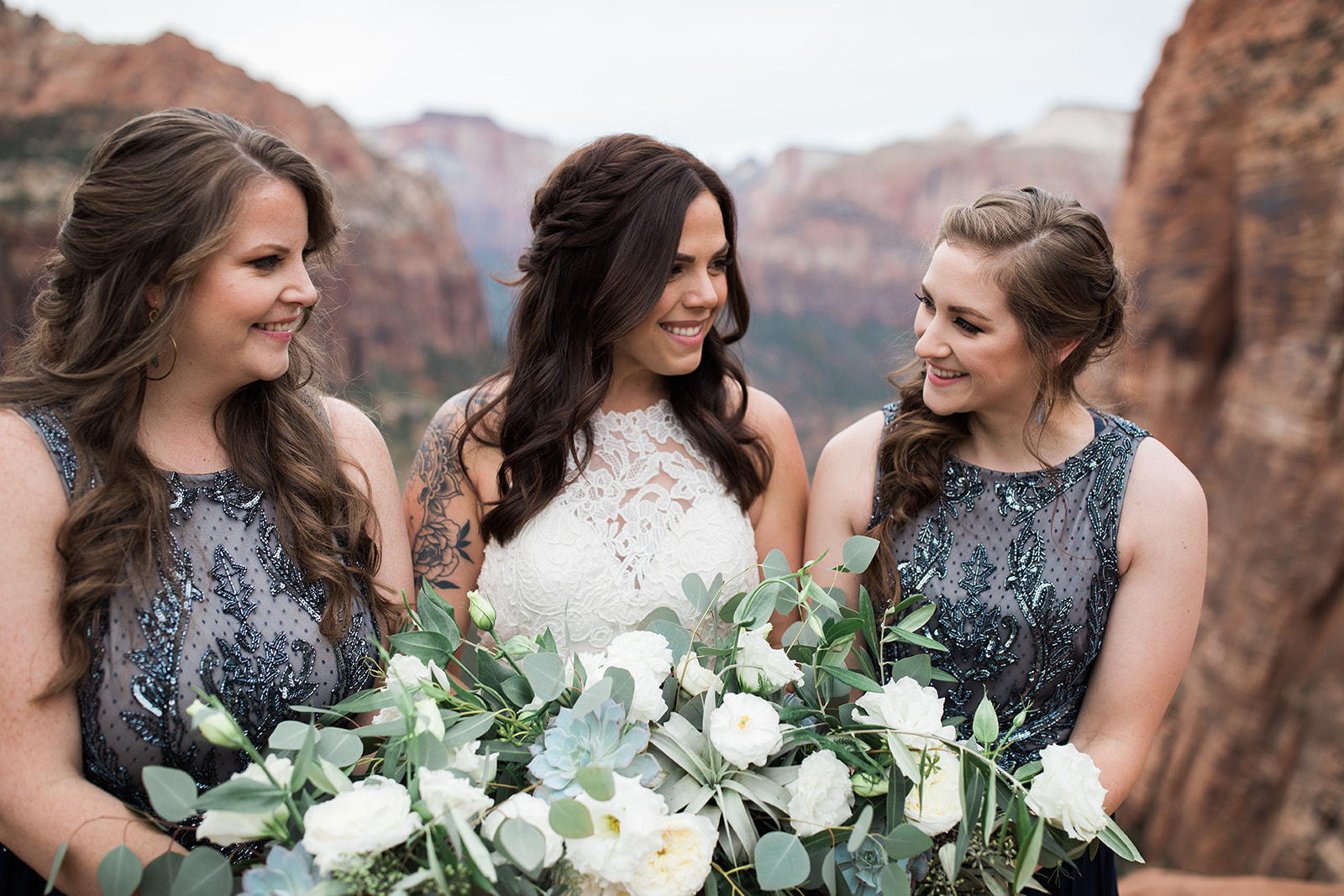 bride and bridesmaids posing in front of Zion mountains
