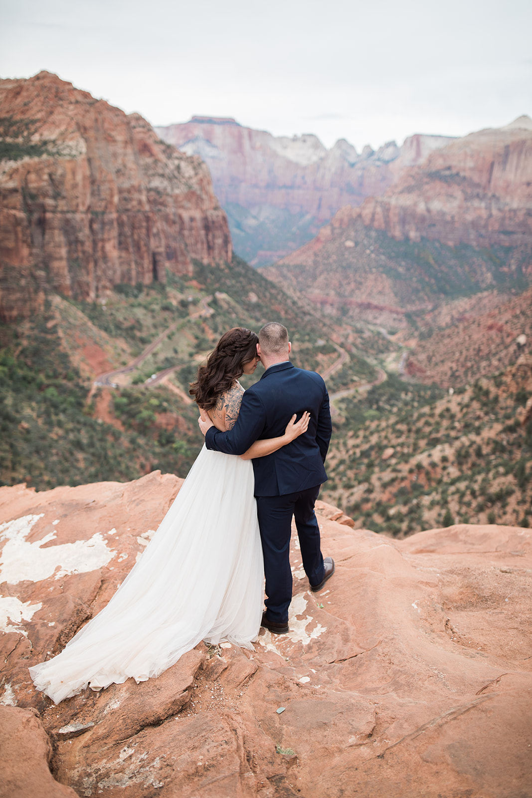 bride and groom look over the Zion National Park vista