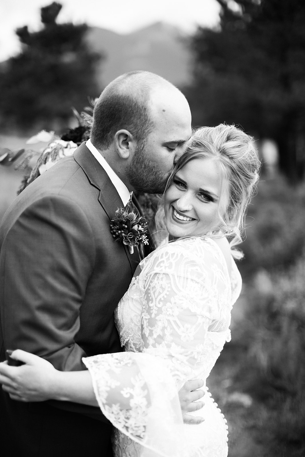groom kisses bride's head after first look