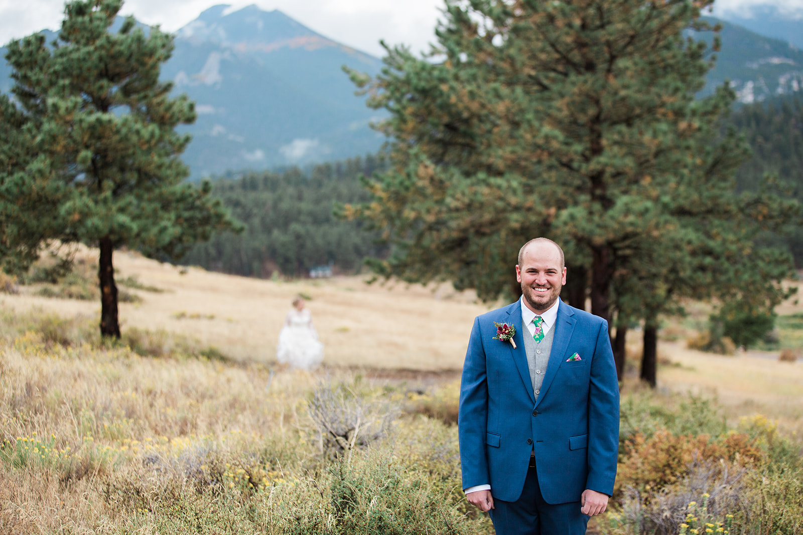 groom waits for bride in rocky mountain national park first look