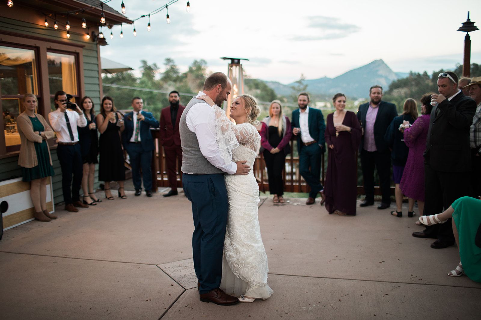 bride and groom first dance outdoor elopement ceremony with view of rocky mountains