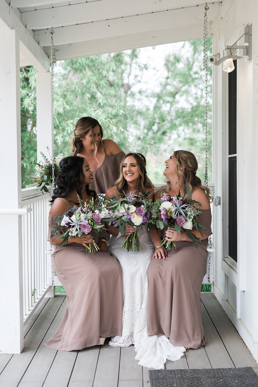 bride and bridesmaids on porch