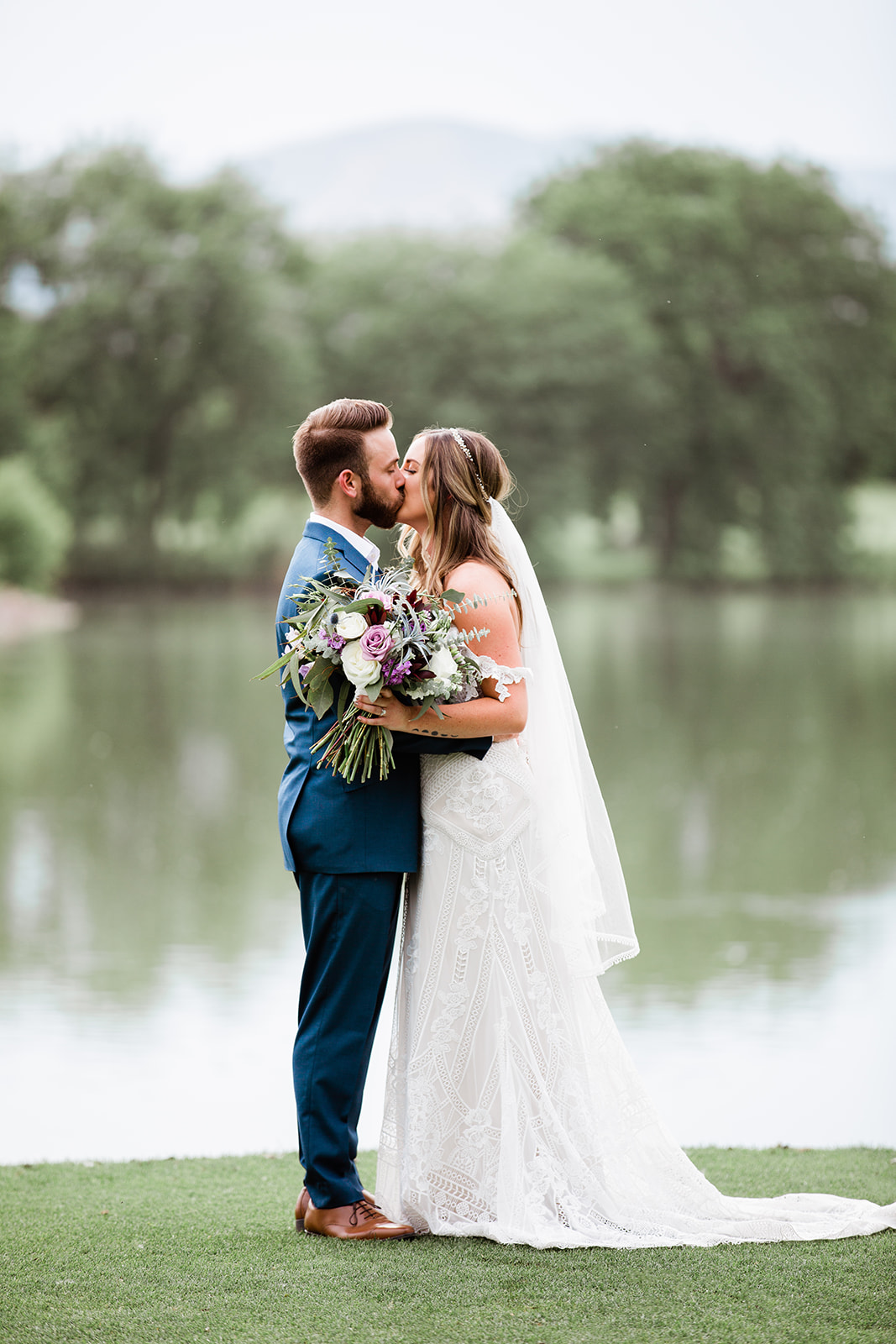 bride and groom in front of lake at Raccoon Creek
