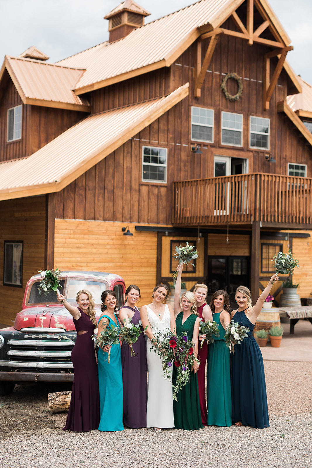 bride and bridesmaids with bouquets at barn in New Mexico wedding