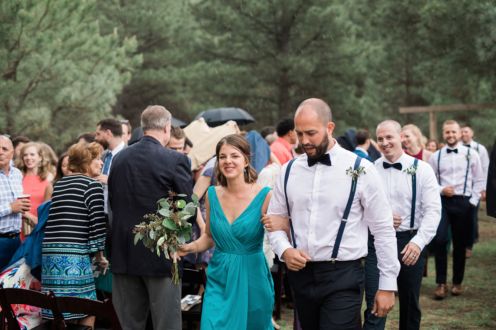 bridesmaids and groomsman walking down aisle in outdoor New Mexico ceremony