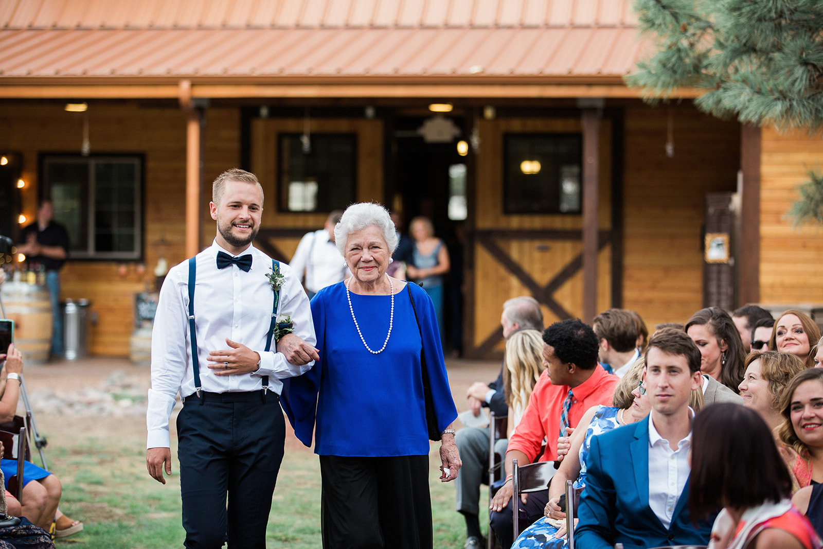 grandma walks down aisle at winery barn wedding
