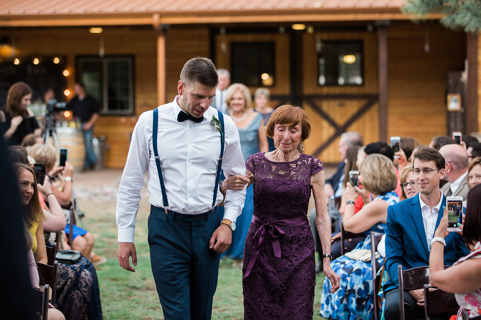 mom walks down aisle at winery barn wedding