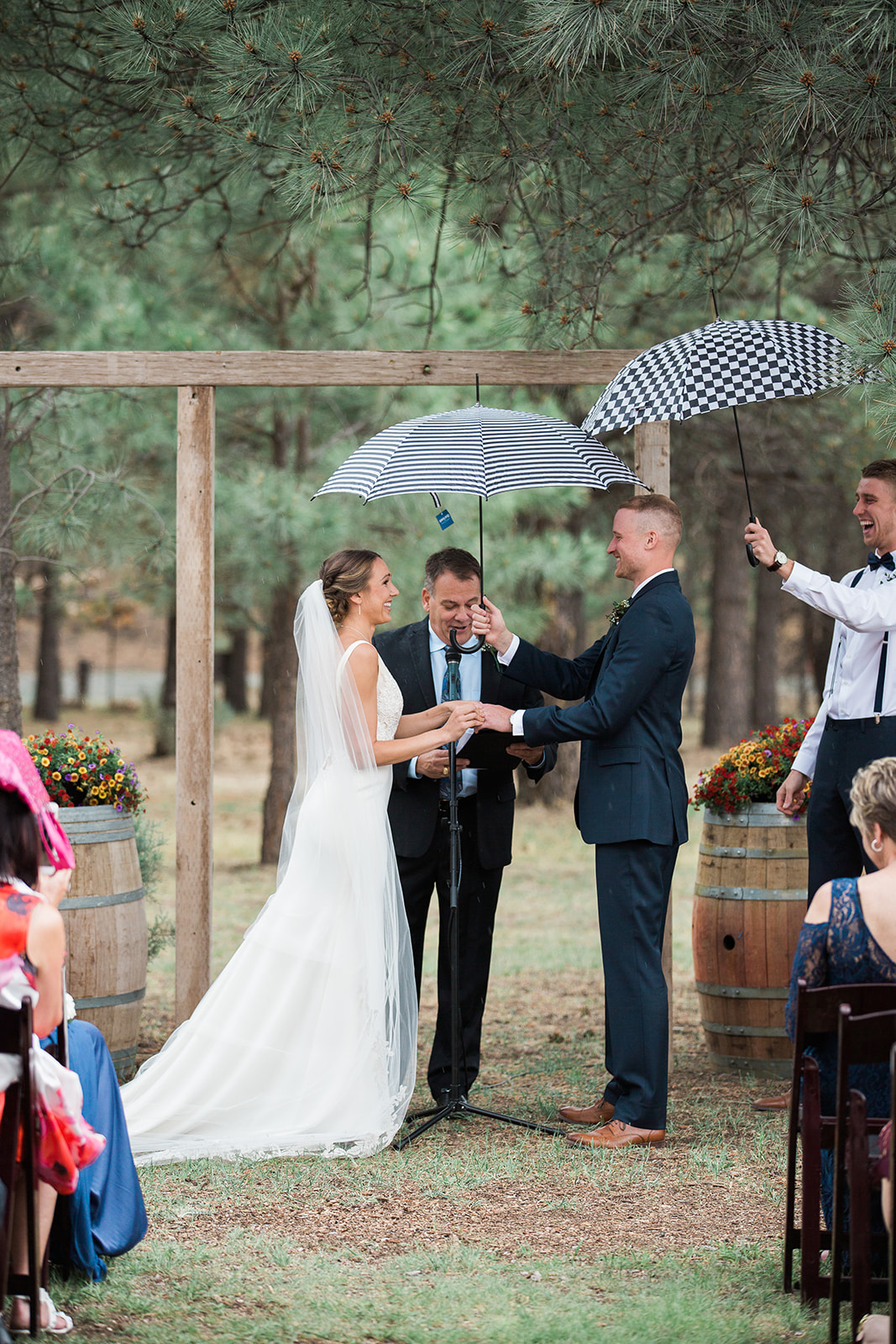 groom puts ring on bride during rainy ceremony in New Mexico