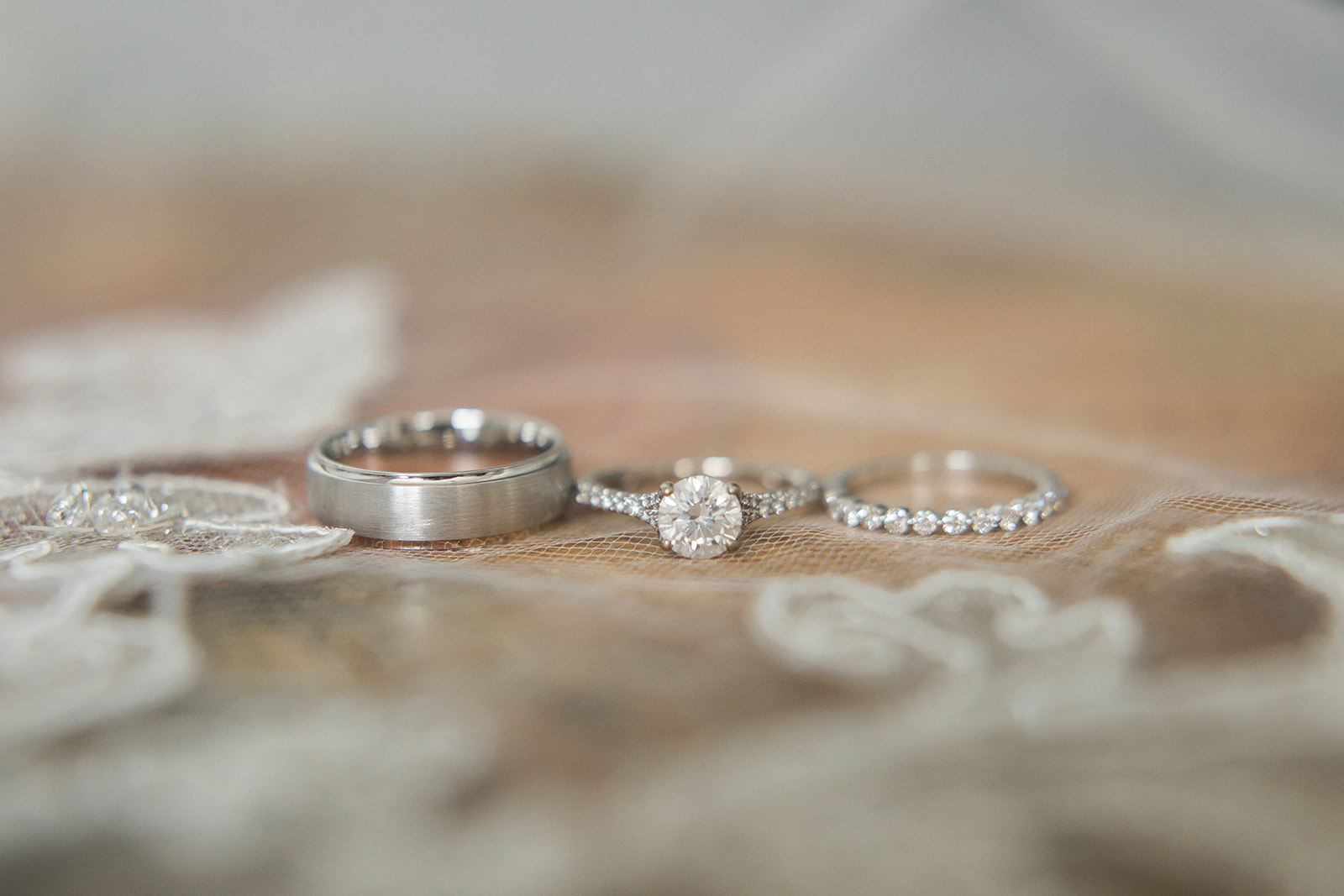 bride and groom rings on lace