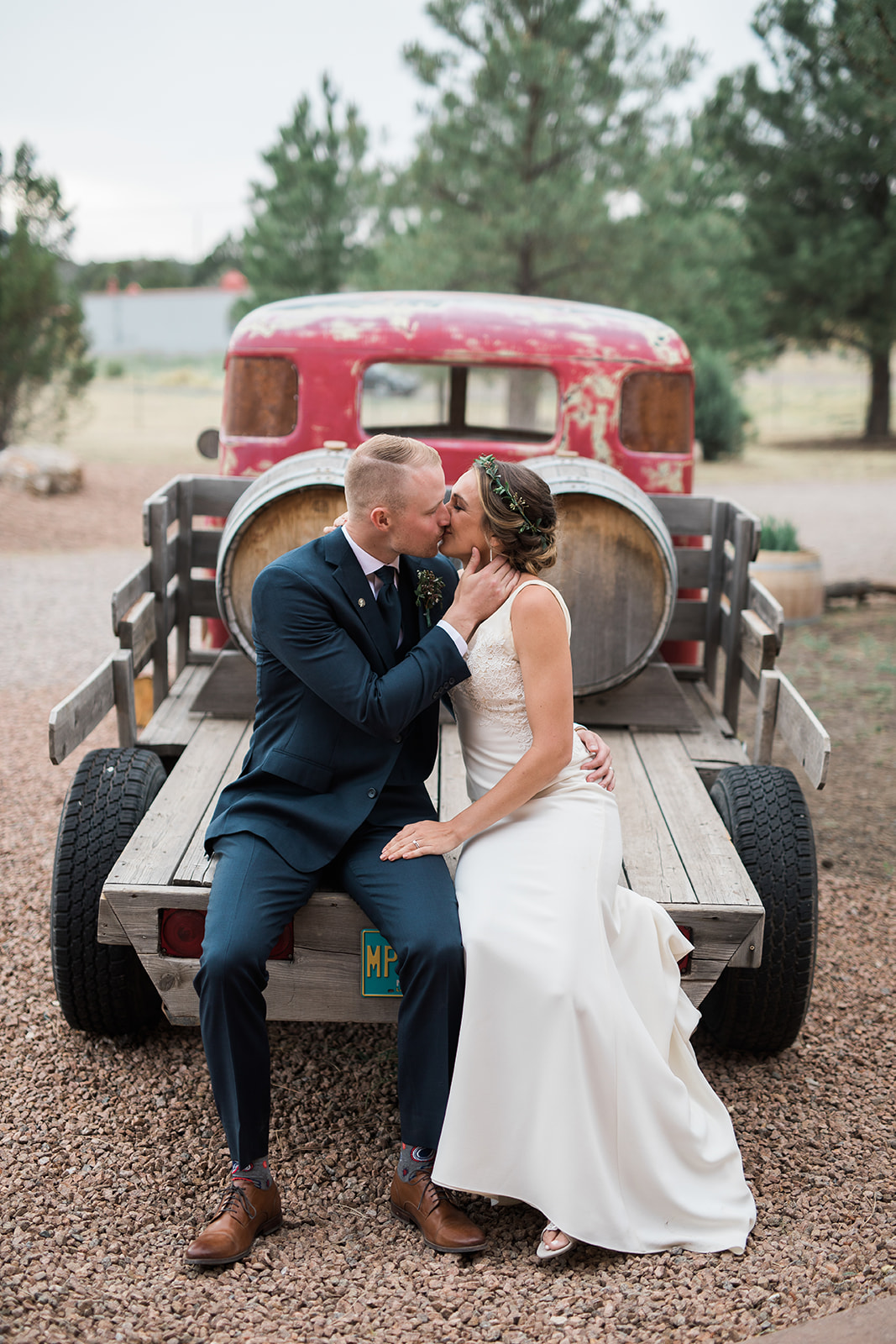 bride and groom kissing on old truck bed