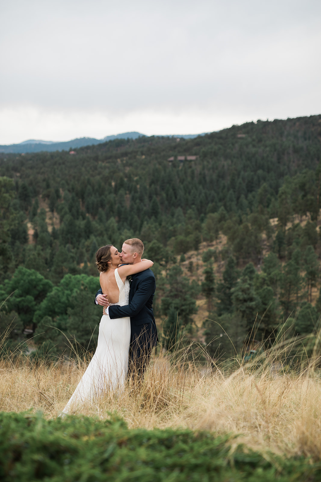 bride and groom in field in New Mexico Winery