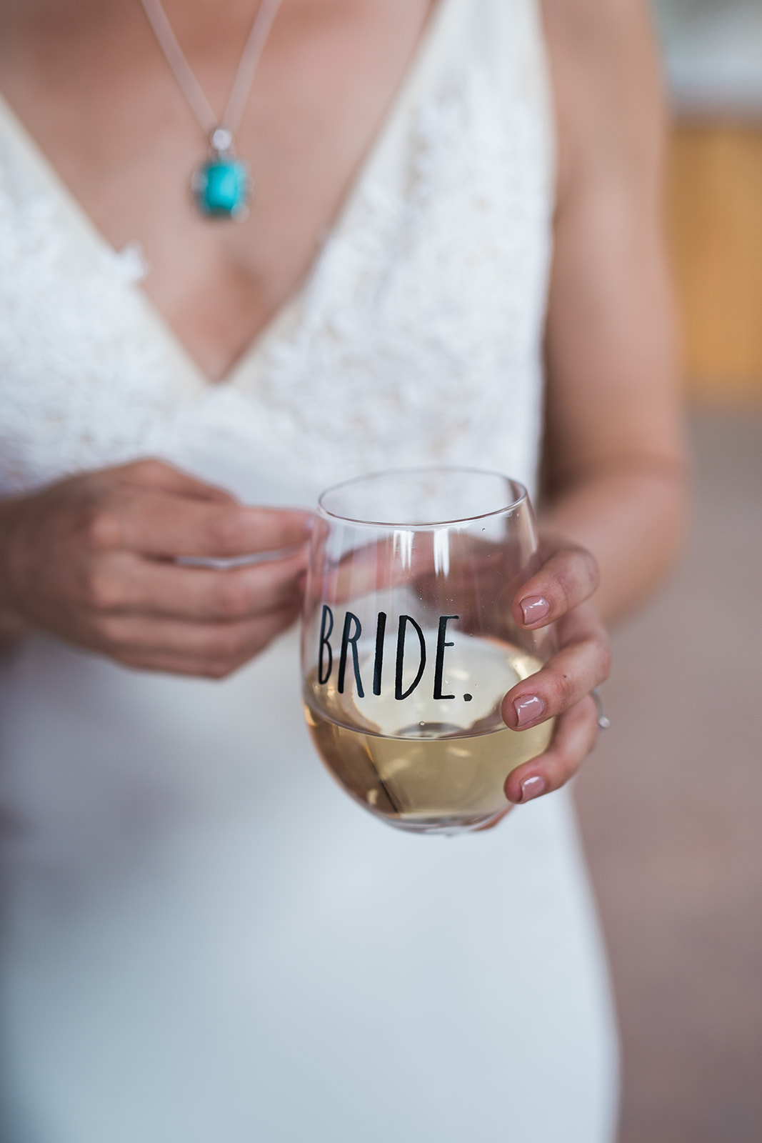 bride holding bride glass of champagne at reception 