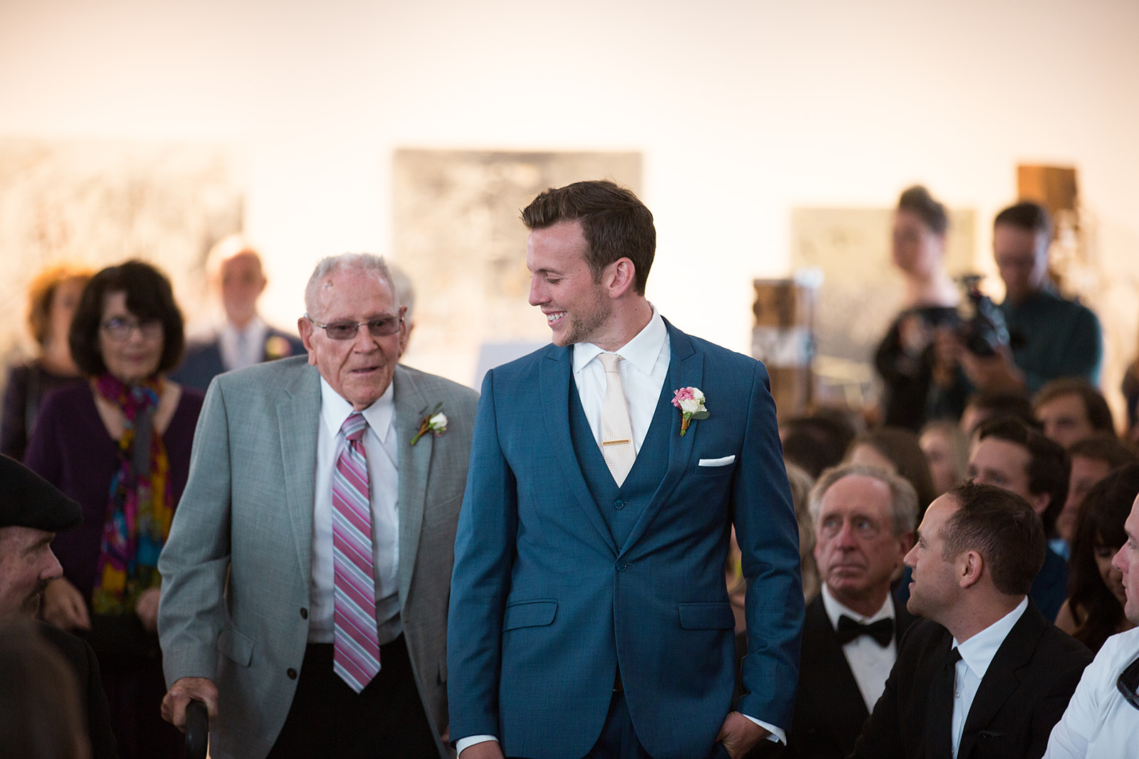 groom walks down aisle in space gallery in Denver wedding