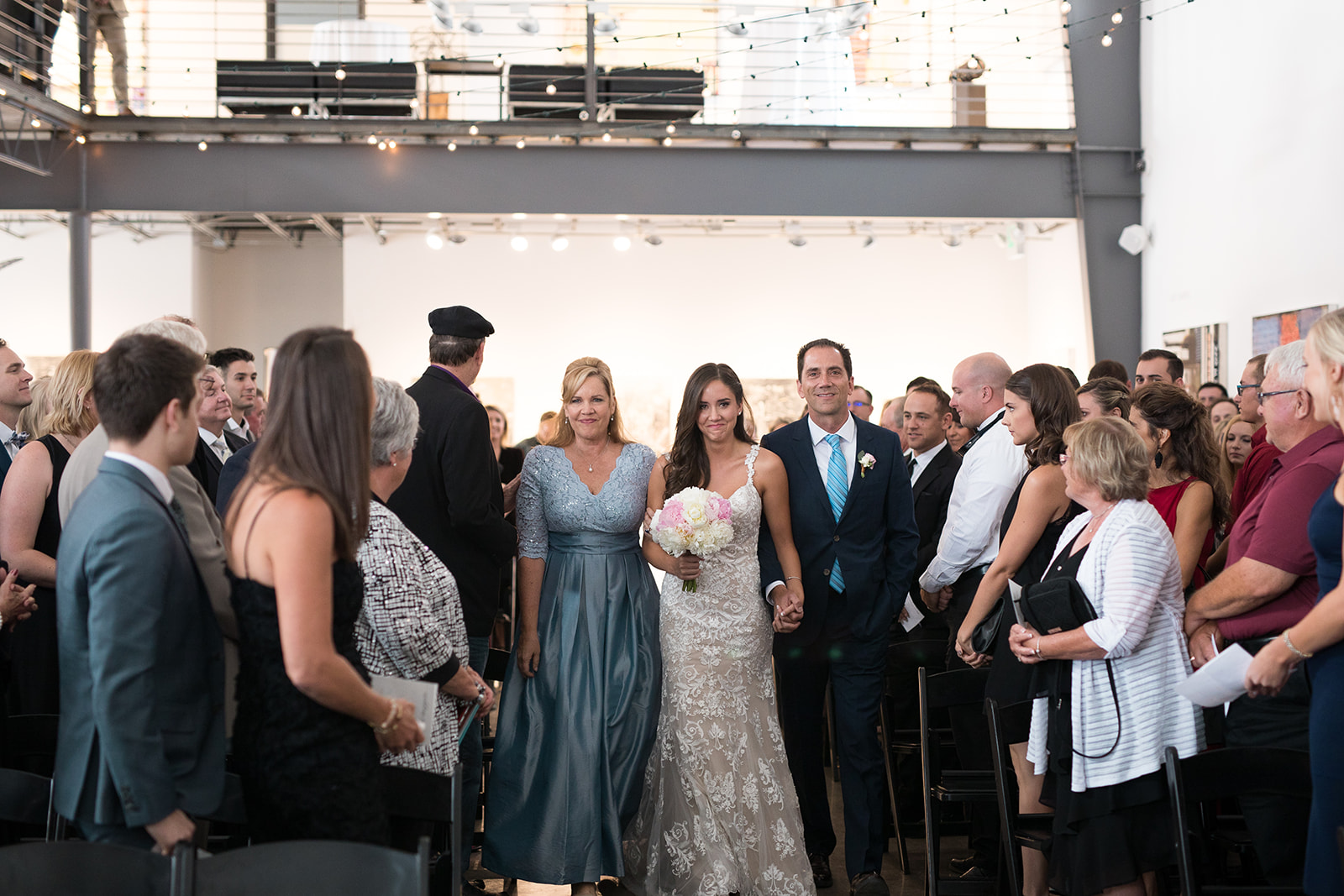 Bride walks down aisle in Space Gallery in Denver