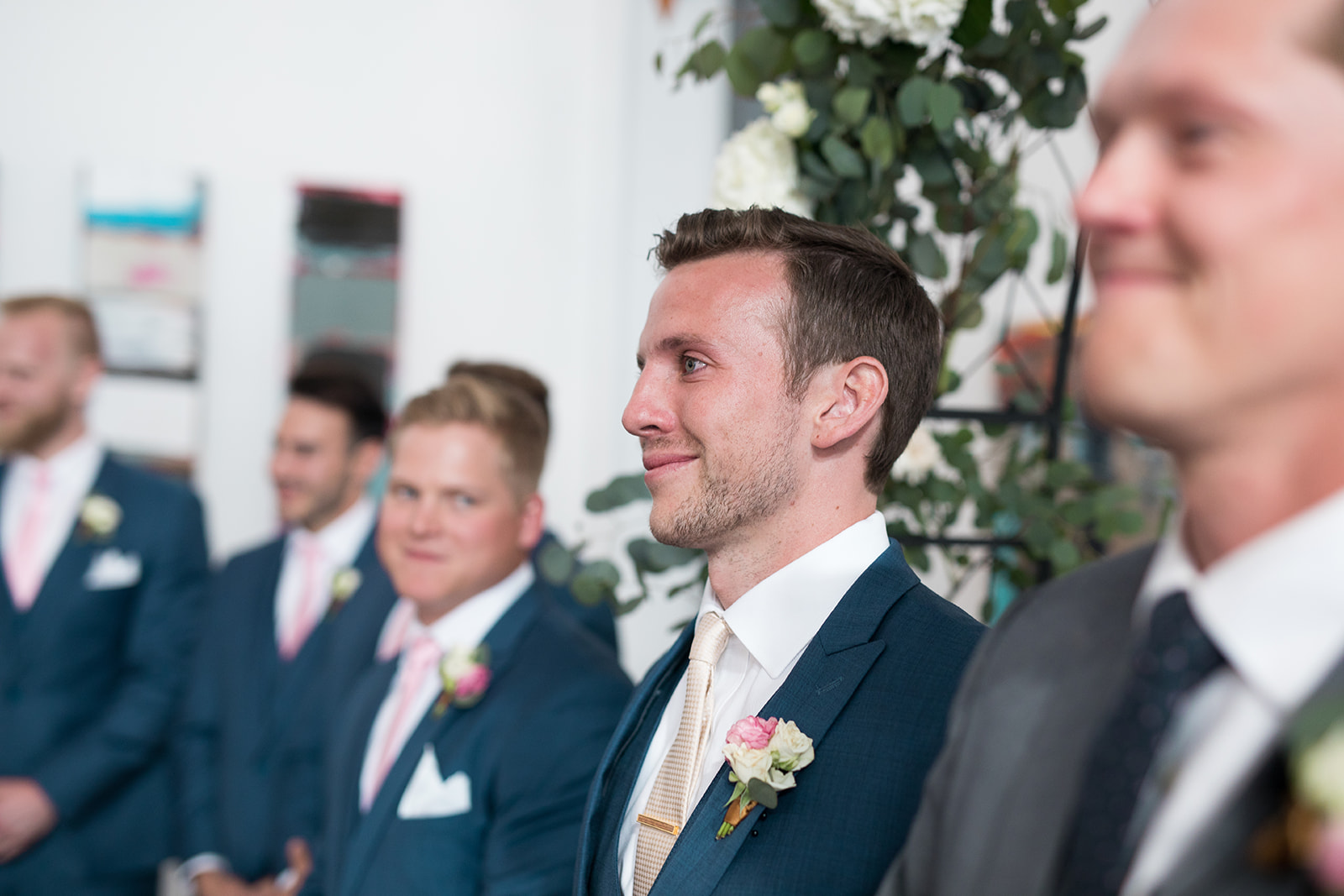 groom watches bride walk down aisle with tears in his eyes