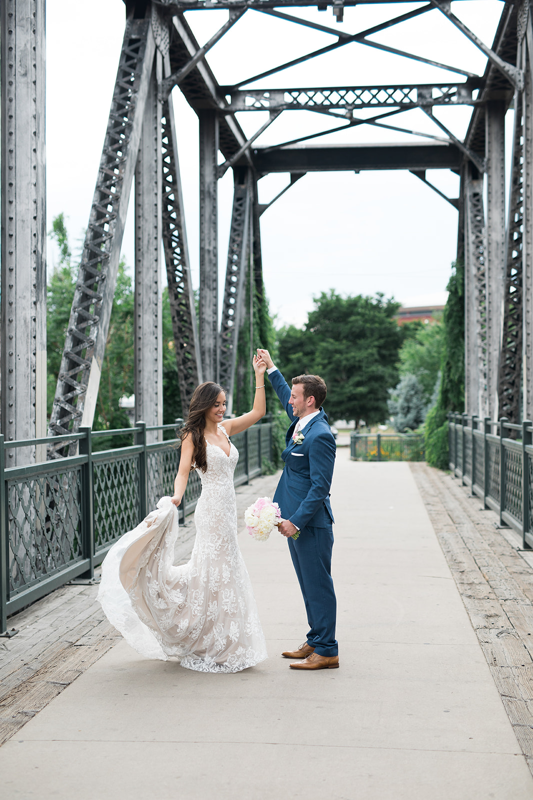 bride and groom dancing on bridge in Denver downtown wedding