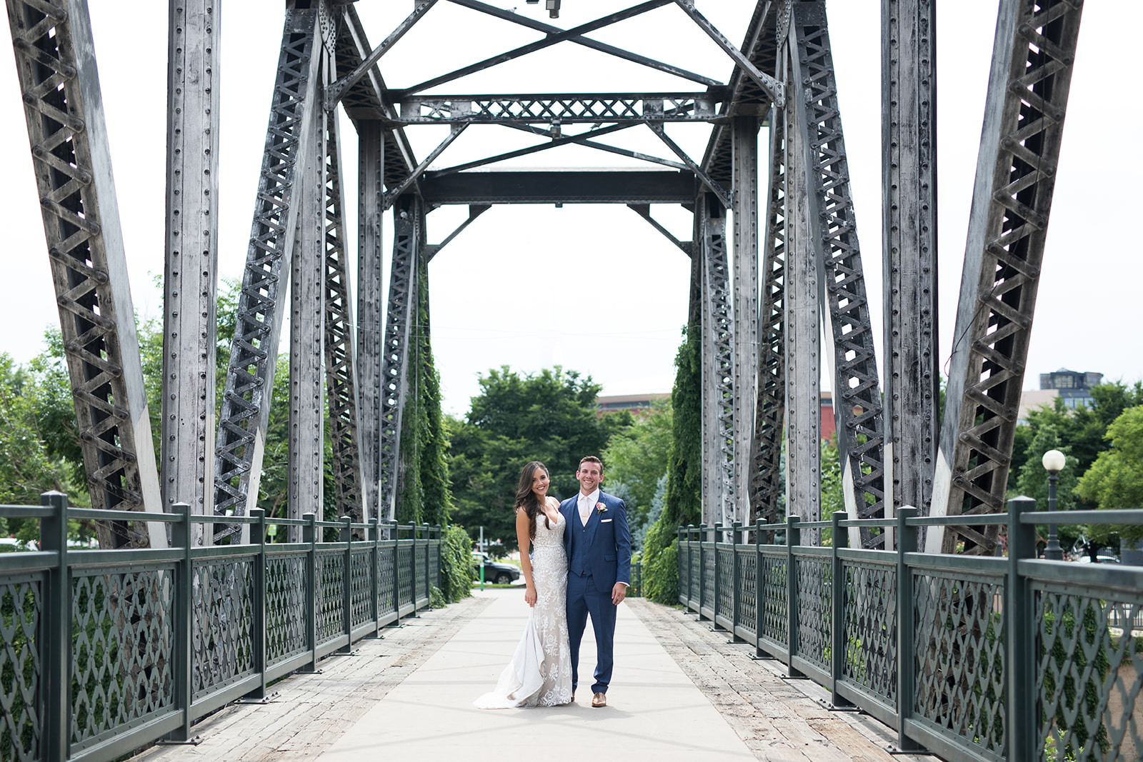 bride and grooms on bridge in downtown Denver