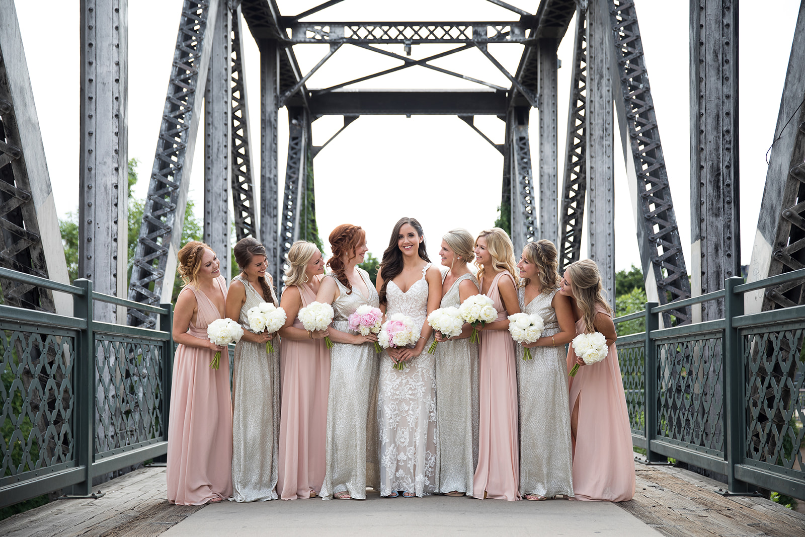bride and bridesmaids on bridge