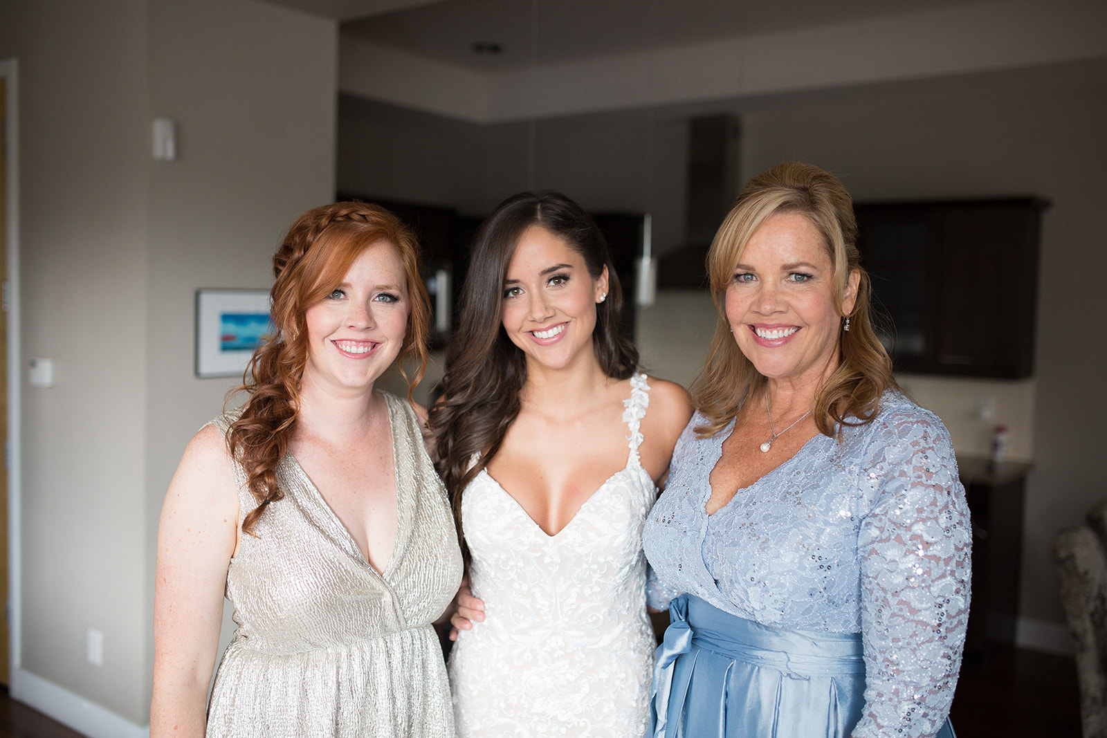 bride and sister and mom posing before downtown denver wedding