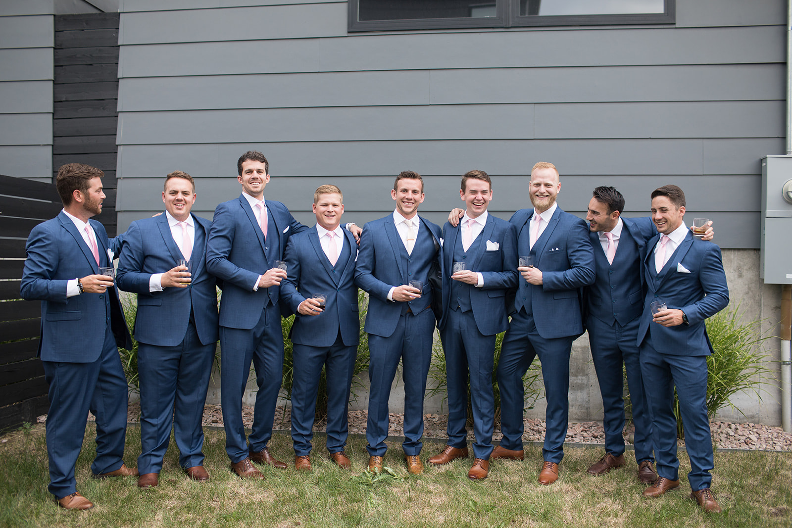 Groom and groomsmen posing for picture before downtown wedding