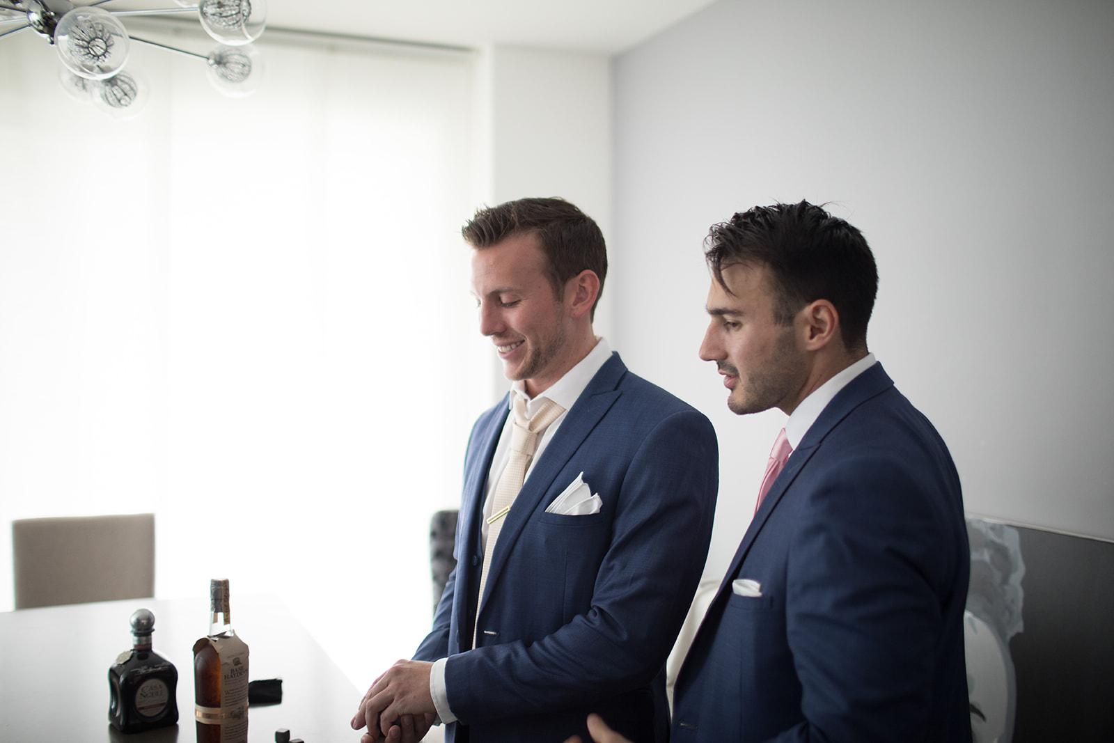 groom and groomsman pouring a drink to celebrate Denver wedding