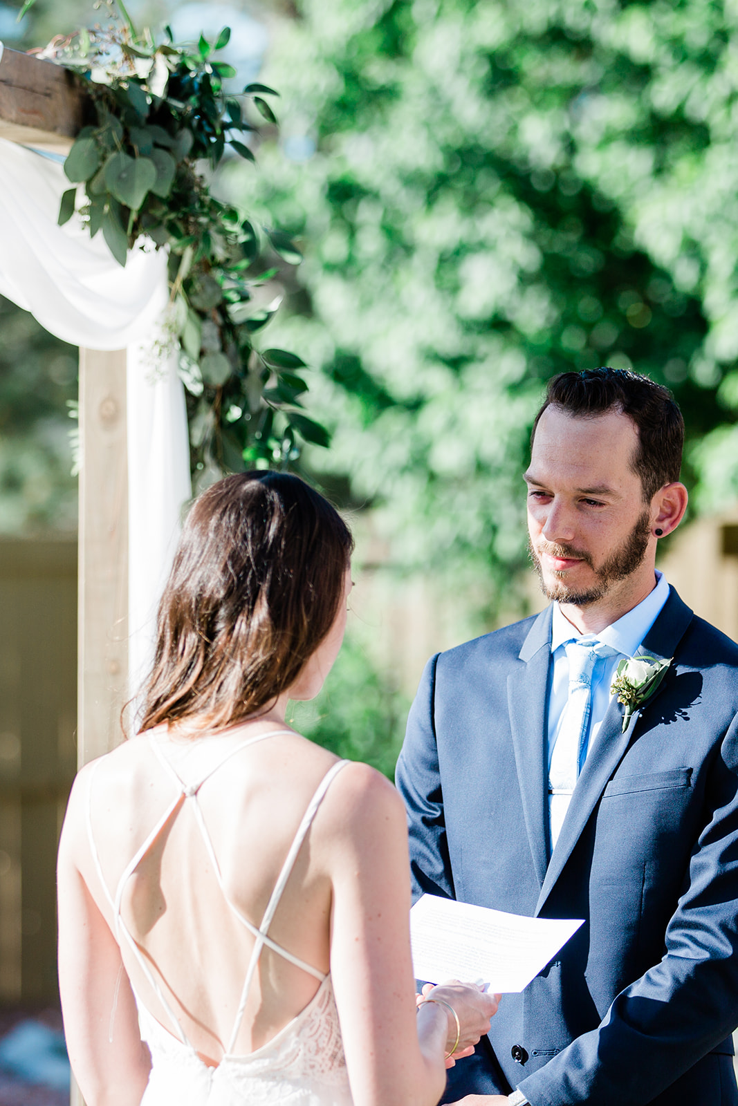 groom reads vows in intimate wedding ceremony