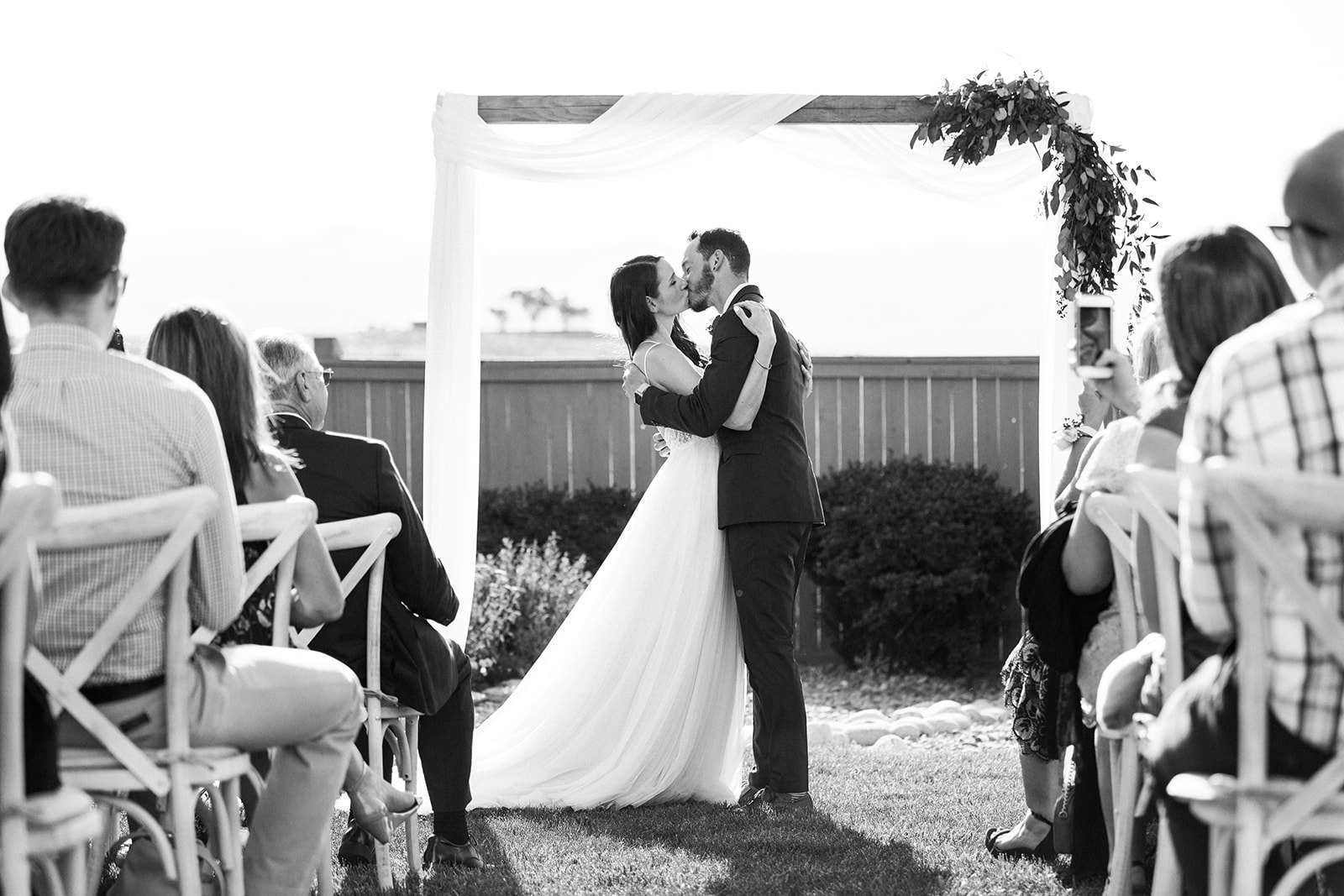 bride and groom first kiss during ceremony
