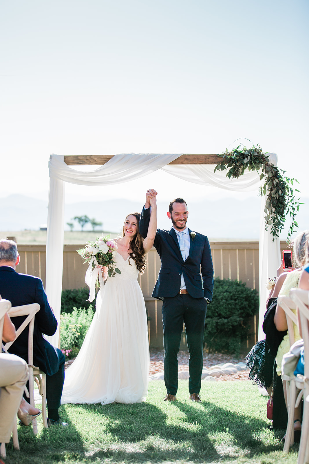 bride and groom celebrate getting married at backyard wedding
