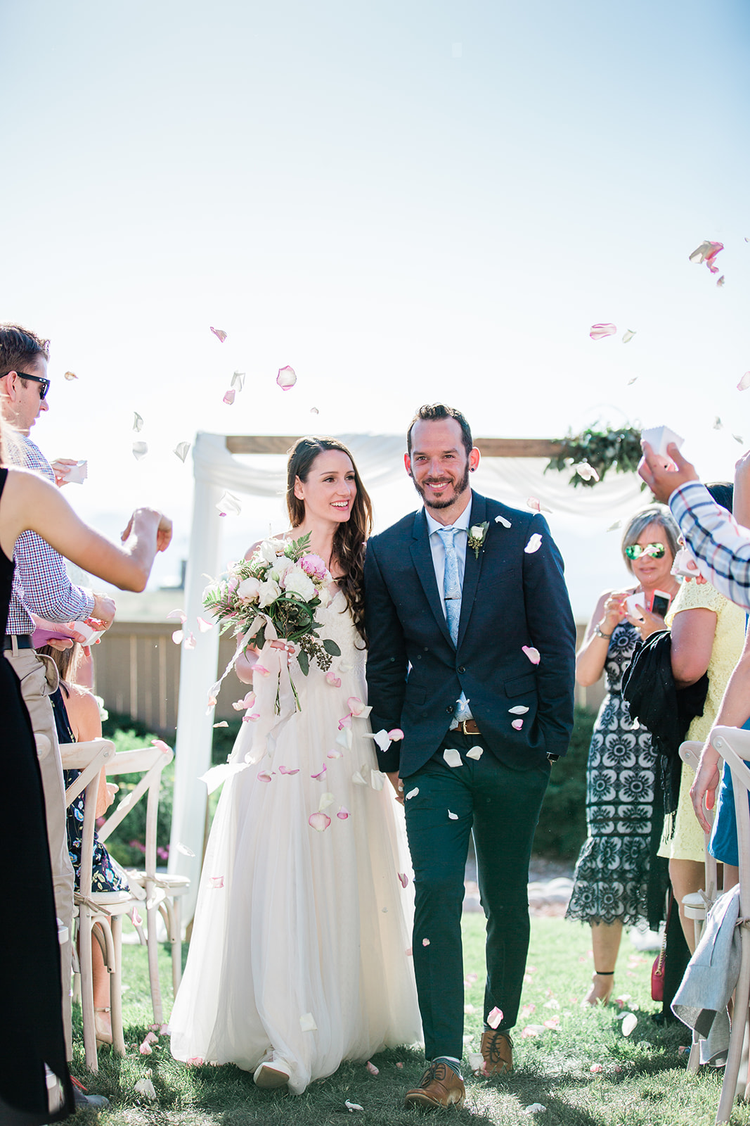 bride and groom celebrate getting married at backyard wedding