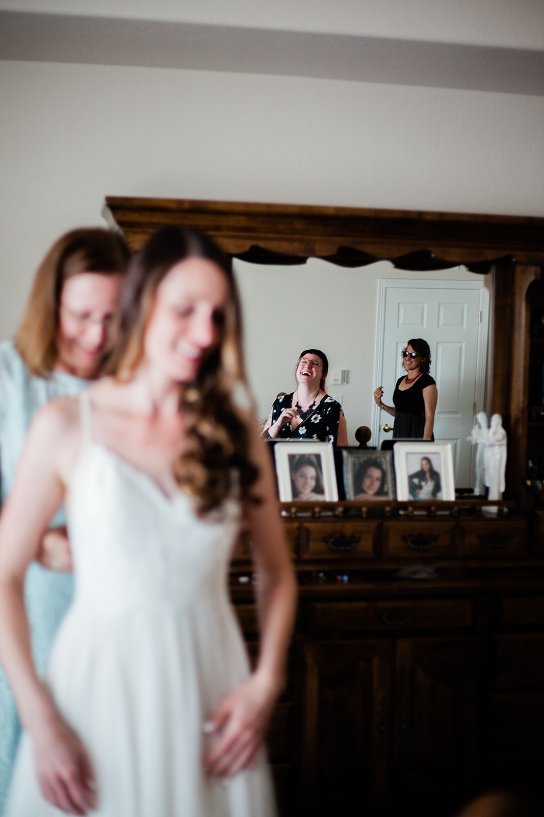 friends watching bride get ready for intimate backyard wedding