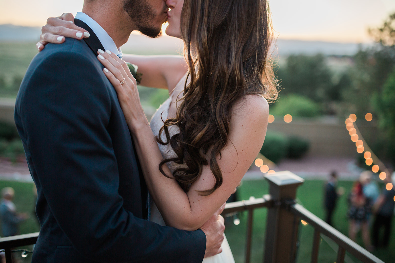 bride and groom kissing on balcony at colorado wedding