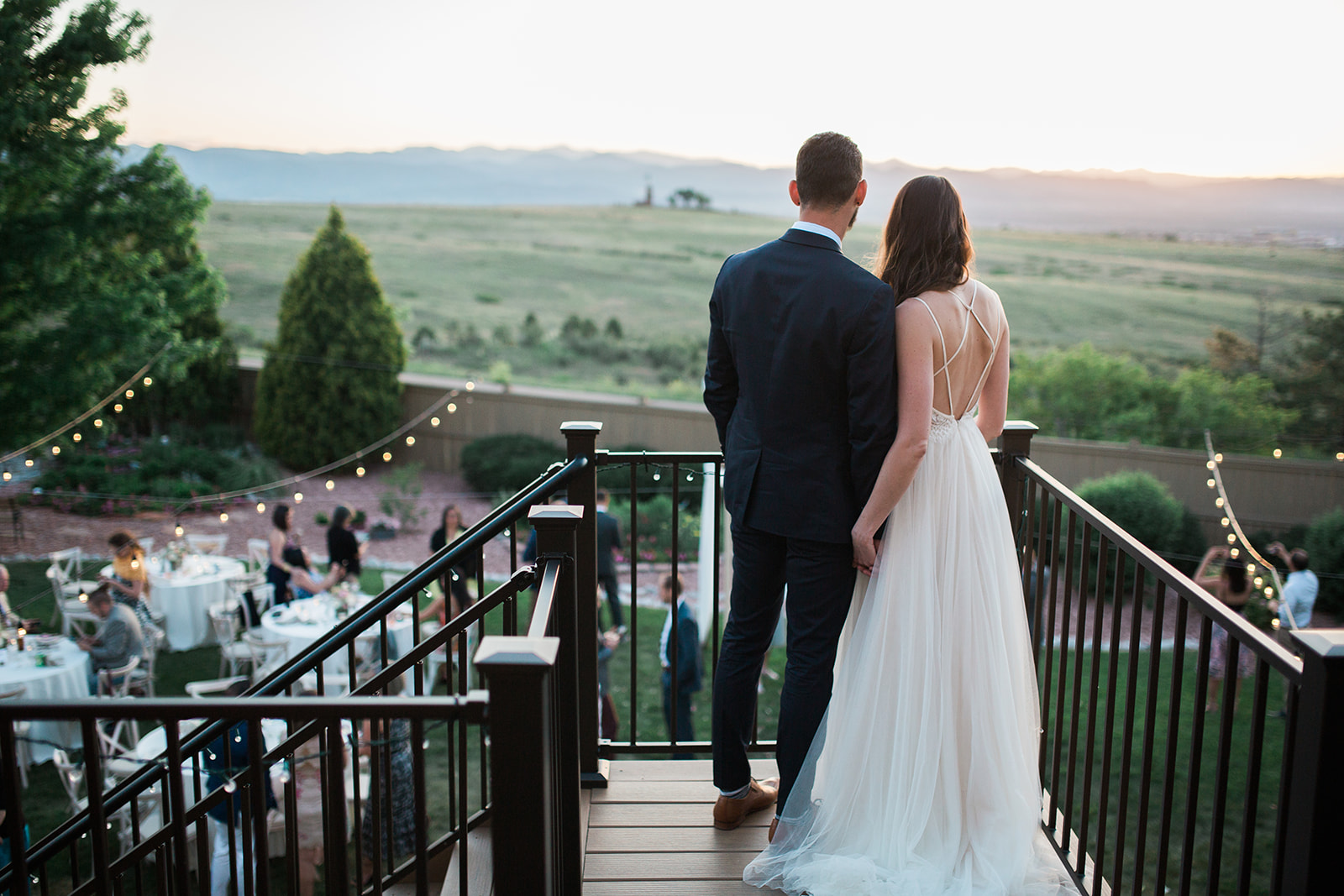 bride and groom looking at view during colorado sunset
