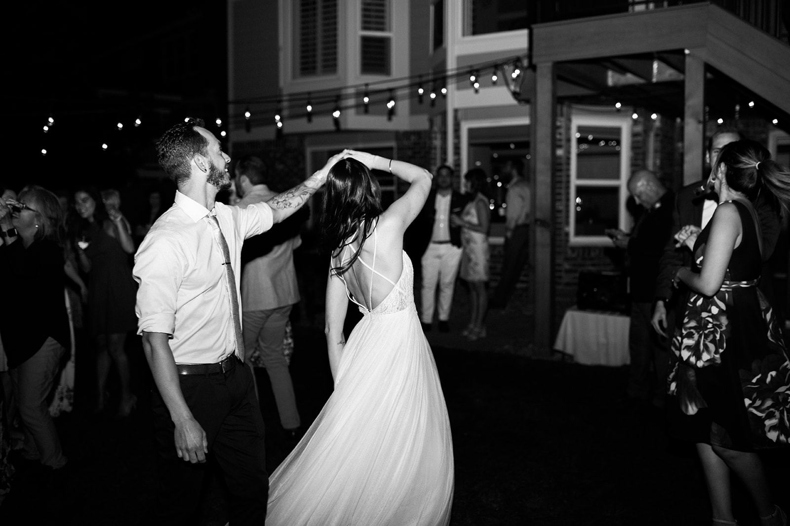 groom spins bride on dance floor at wedding reception