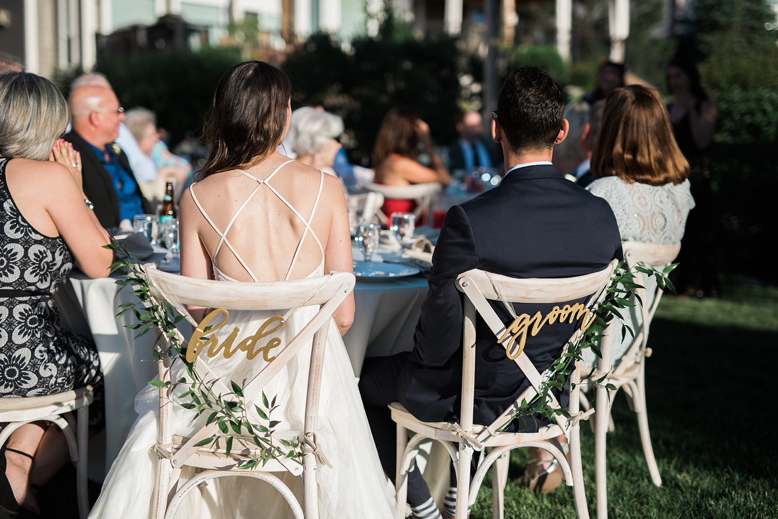 detail of bride and groom's chairs at wedding reception
