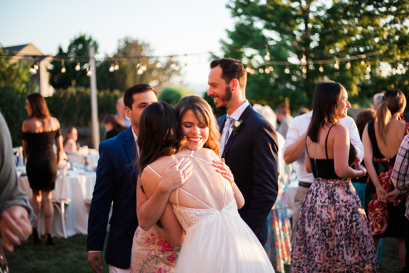 bride hugging friend at outdoor colorado wedding reception