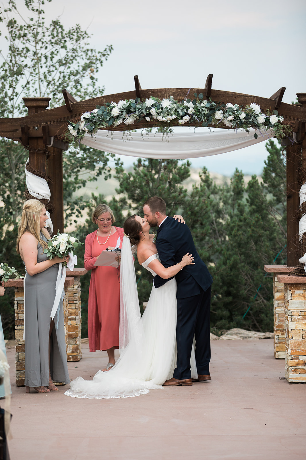 first kiss under altar at willow ridge manor in morrison Colorado