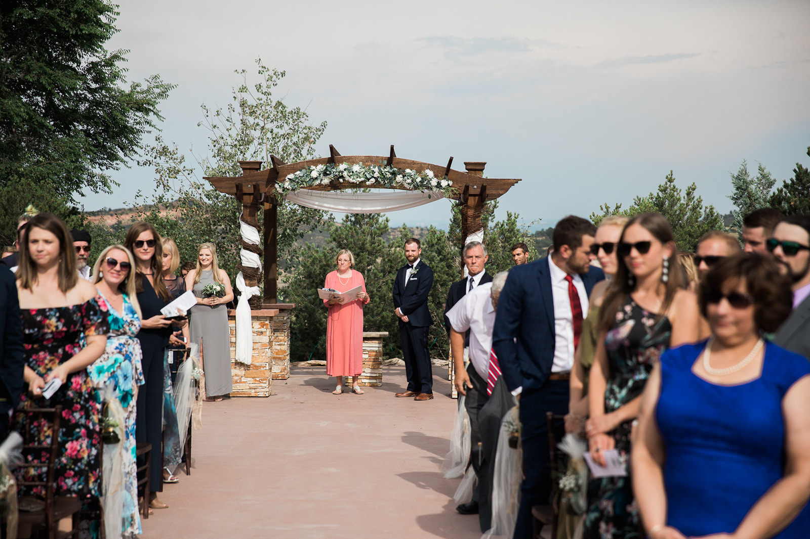 groom waits for bride to walk down aisle at Willow Ridge Manor, outdoor colorado wedding ceremony