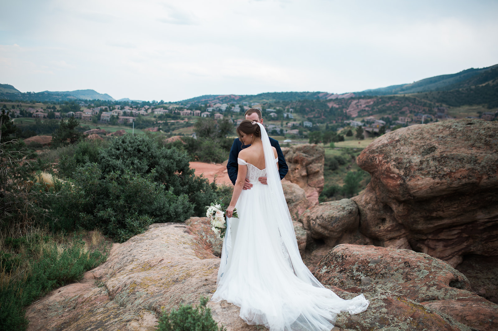 willow creek manor bride and groom walking on sandstone in Morrison Colorado