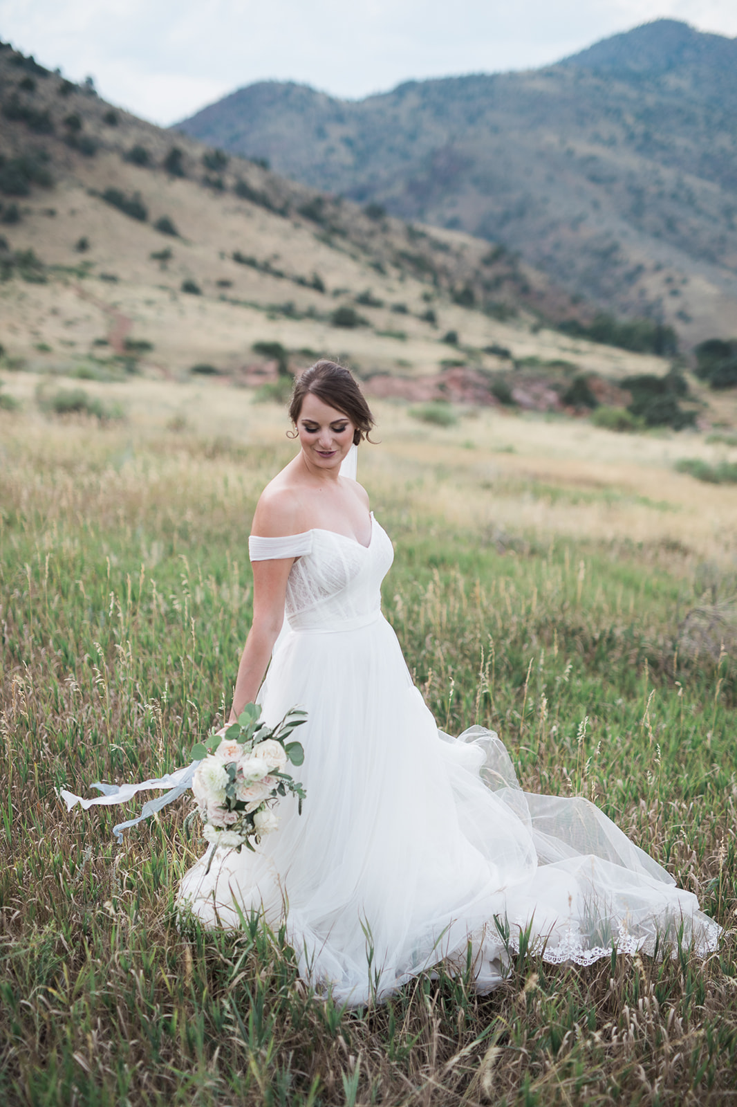willow ridge manor bride posing in mountain meadow