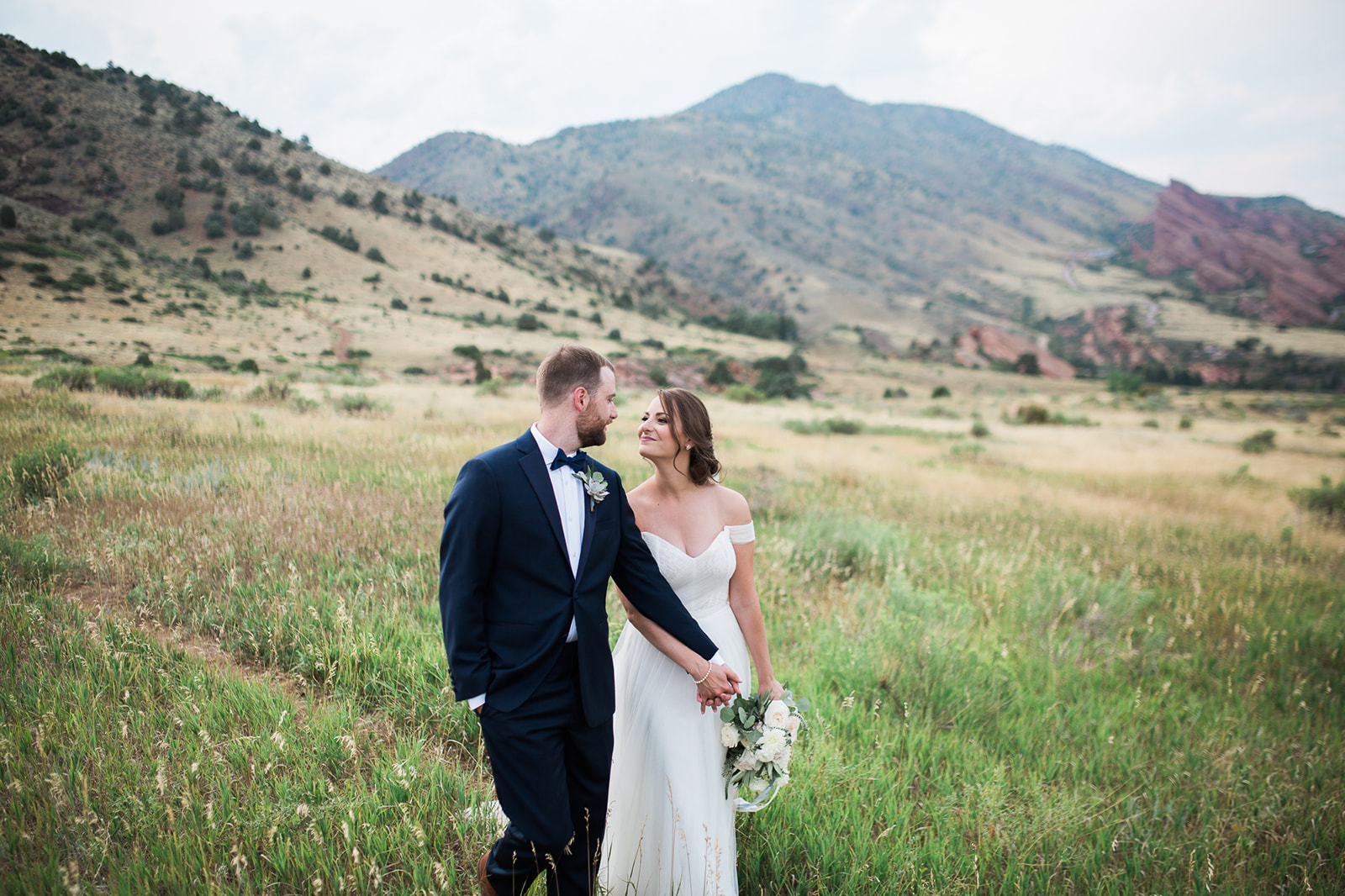 willow ridge manor bride and groom posing in mountain meadow