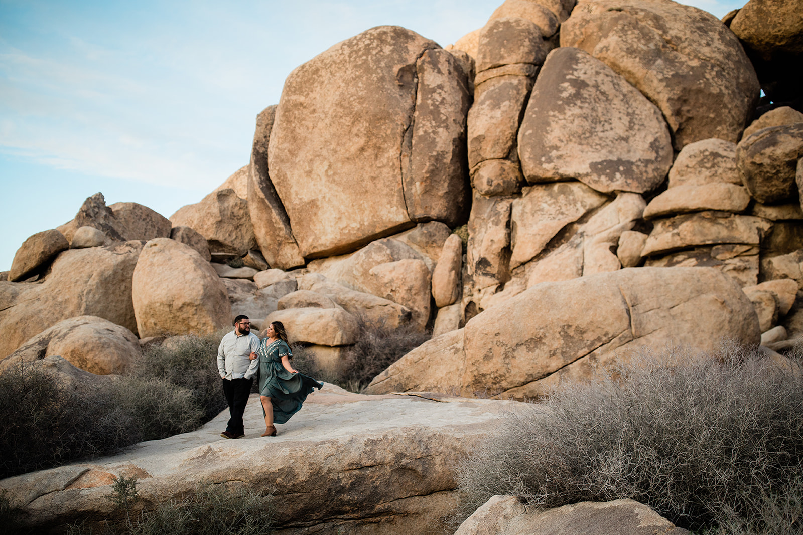 engaged couple on rock outcropping