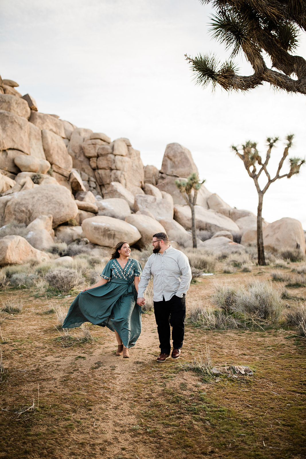 couple poses for engagement picture in Joshua Tree Park