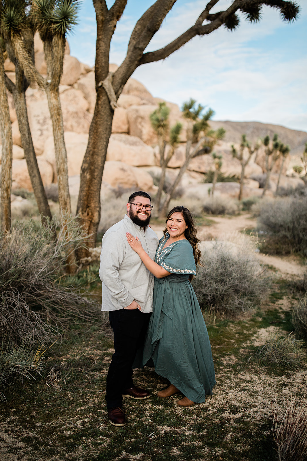 engaged couple dancing under a Joshua Tree