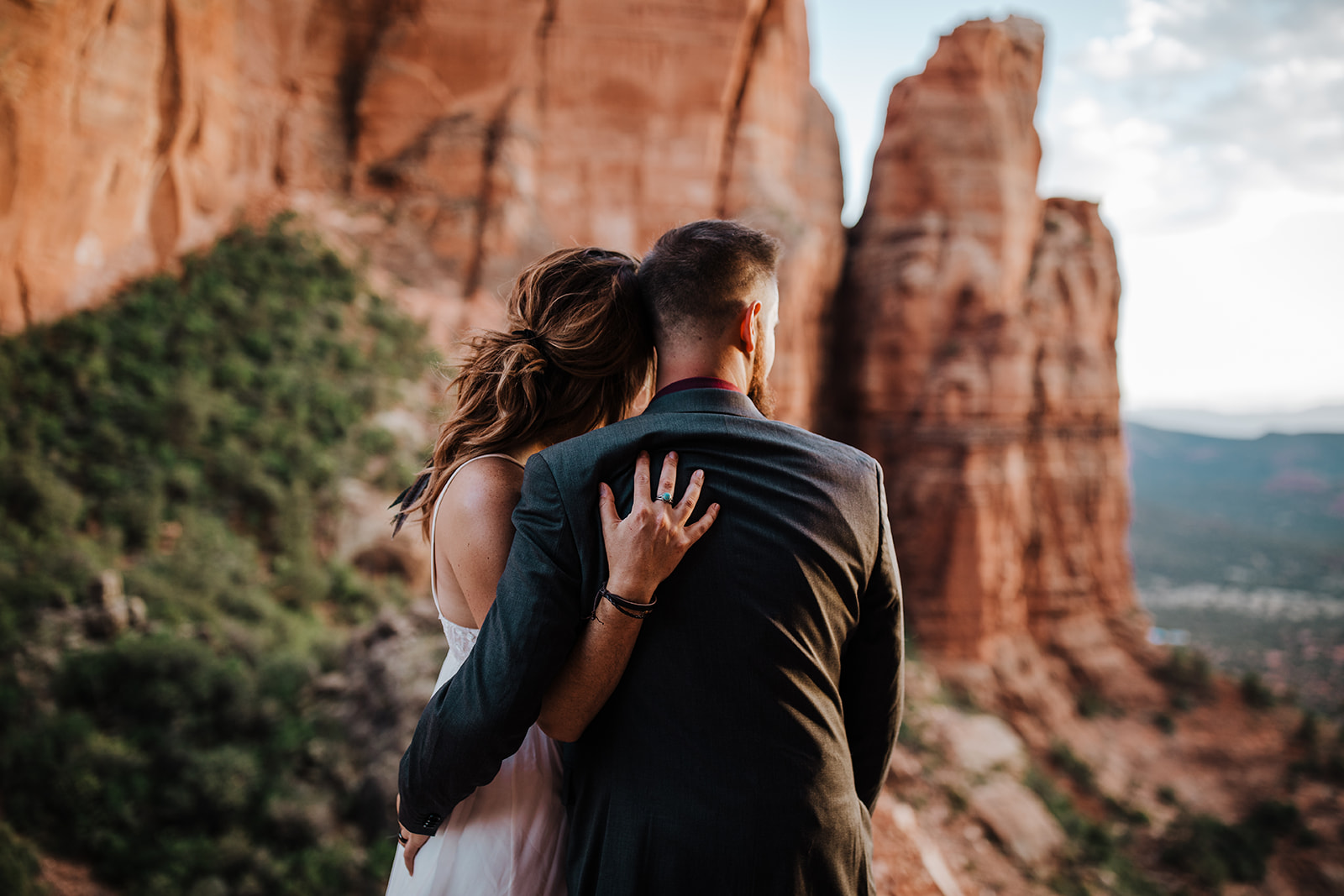 bride and groom look out over the Sedona desert after elopement
